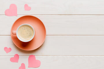 Mug coffee and gift box on colored background. Flat lay composition. Holiday concept