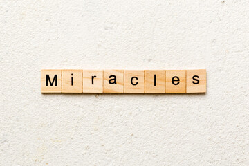 miracles word written on wood block. miracles text on cement table for your desing, concept