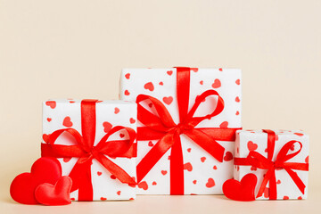 gift box with red bow and red heart on colored background. Perspective view. Flat lay