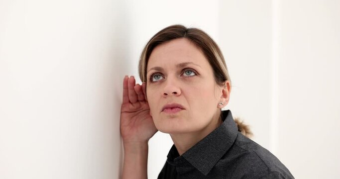 Portrait of curious woman gesture to eye to ear carefully intently listening behind wall. News and gossip