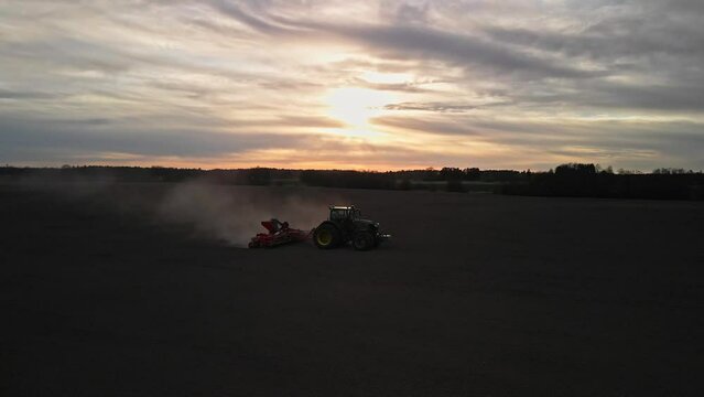 Tractor plowing in the sunset