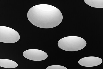 Dark ceiling with round skylight portals, abstract minimal architecture