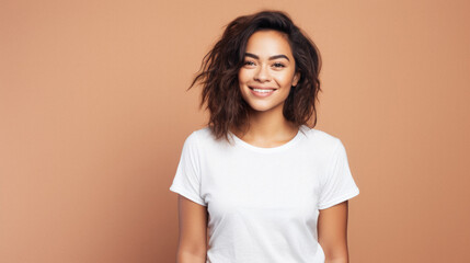 Fototapeta premium Young happy smiling Latin woman model wearing tshirt standing on color background. Face skin treatment, curly hair care cosmetics makeup, fashion ads. Beauty portrait. White t-shirt mock up template .