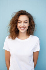 Young happy woman, smiling gen z girl model wearing tshirt looking at camera standing on color background. Face skin care cosmetics makeup, fashion ads. Beauty portrait. White t-shirt mock up template