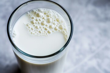a glass of milk with bubbles