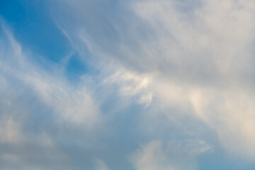 Blue sky with white soft wispy high clouds