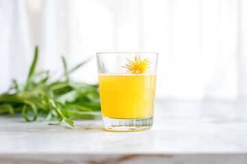 fresh dandelion detox juice in a clear glass