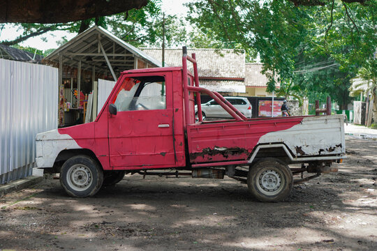 an old pick up truck painted in red and white in a rustic and classic style