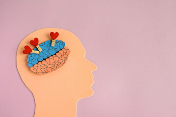 Symbol of a human head and a brain filled with hearts. Concept of a happy or loving person. Mental...