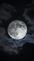 full moon white glowing with craters in black sky with clouds at night