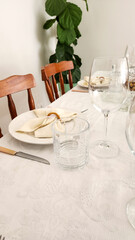 dining table decorated with plates and glasses