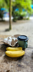 breakfast with tropical fruits in the middle of nature with two coffee mugs