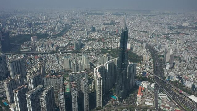 Aerial view of Landmark Central Park, Saigon River and Ho Chi Minh City Skyline, Vietnam on a sunny day. Camera orbits CCW  to reveal River and city skyline.