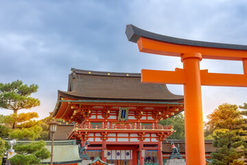 Fushimi Inari Shrine view with Torii gates in front. The translation of the sign from Japanese...