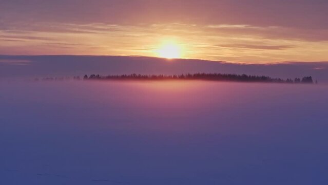 Sunset with fog in winter