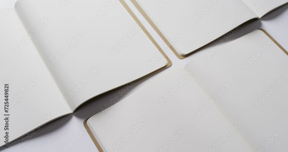 Poster close up of open blank books with copy space on white background in slow motion