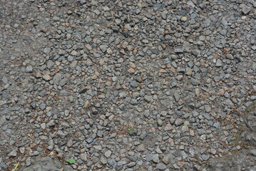 A construction road covered with gray small pebbles.