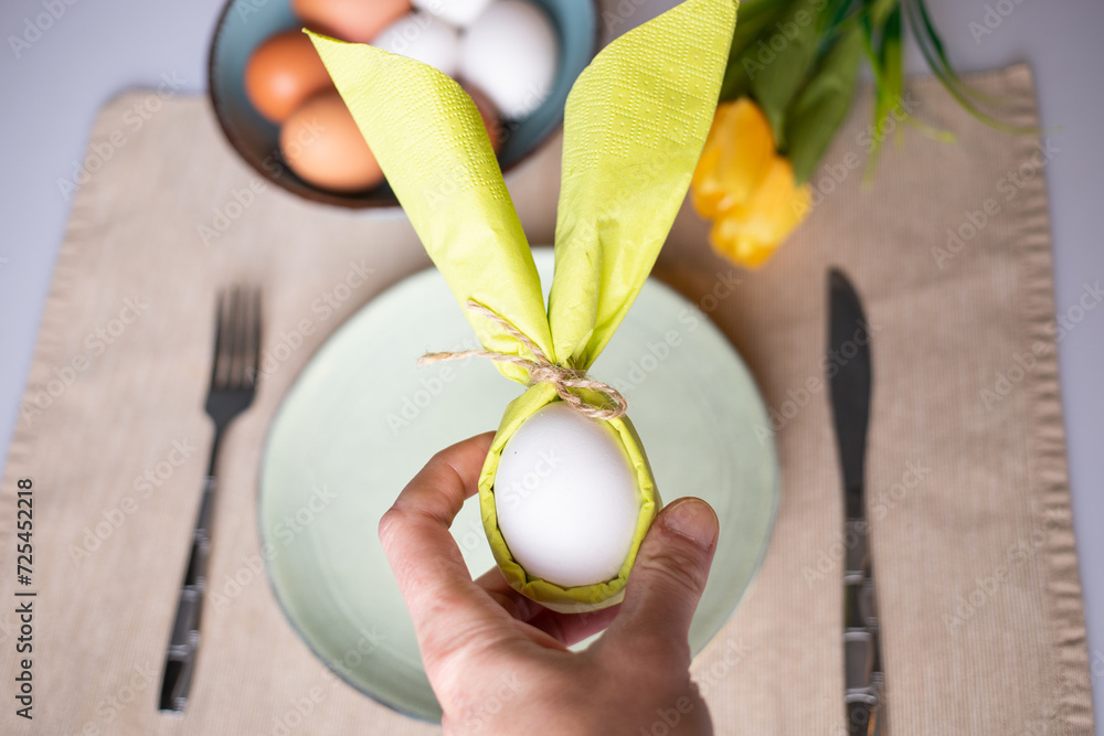 Wall mural egg wrapped in bunny shaped napkin