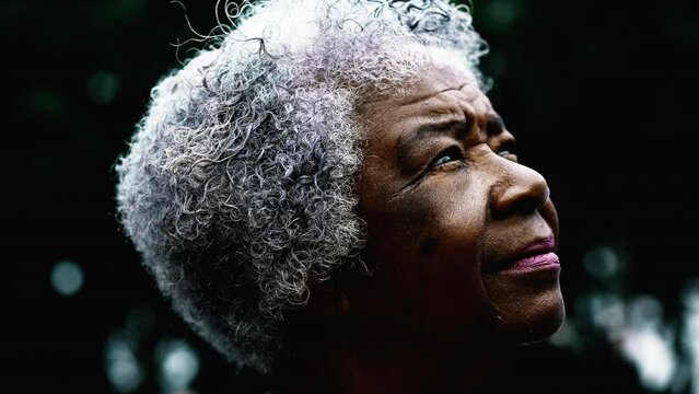 Close-up face of a gray hair senior woman gazing eyes upwards, wise wrinkled elderly 80s lady in peaceful contemplative emotion feeling presence of a Higher power