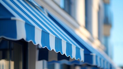 A row of blue striped awnings on a building facade. - obrazy, fototapety, plakaty