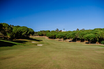 Sotogrante, Spain - January 25, 2024 - A spacious golf course fairway bordered by trees with a...