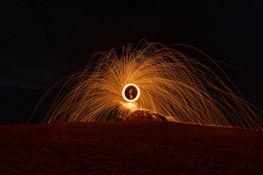 Person fire dancing with steel wool, Bromo-Tengger-Semeru National Park, East Java, Indonesia