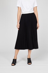 Black women's luxury Classic Long Maxi pleated skirt on model isolated on white background. Woman wearing Midi folded Accordion Skirt, summer autumn outfit. Top view. Template, concept