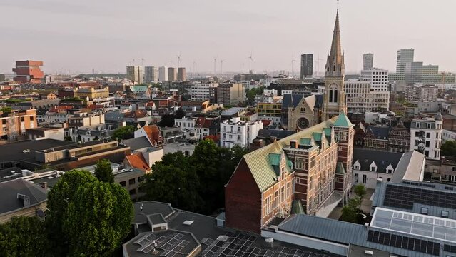 Antwerp city view with church towers and wind generators at background