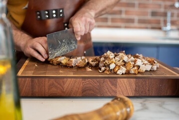 chopping slices of chicken with a knife