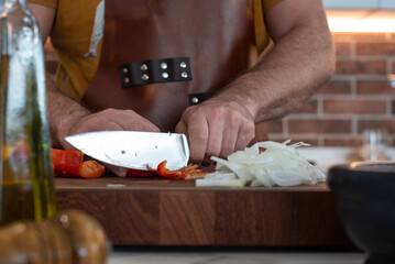 men cutting with a knife vegetables