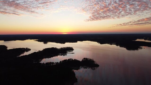 Drone footage of a sunset over a lake