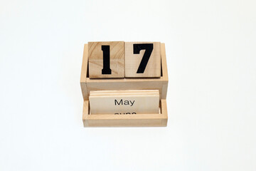17h of May wooden perpetual calendar. Shot close up isolated on a white background
