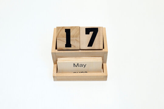 17h of May wooden perpetual calendar. Shot close up isolated on a white background