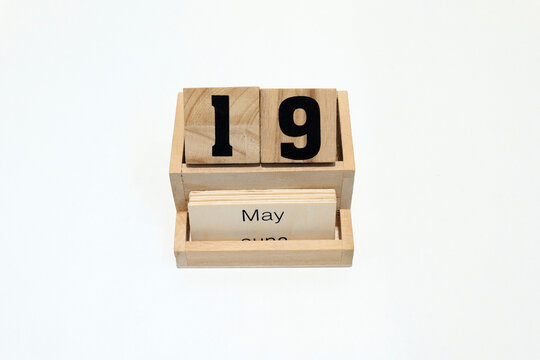 19h of May wooden perpetual calendar. Shot close up isolated on a white background
