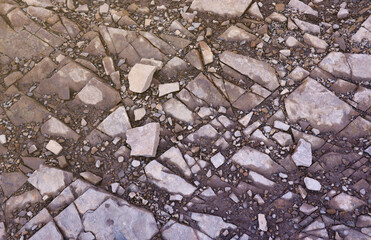 Background of shattered stony stones surface in mountain area. Flat texture with natural light