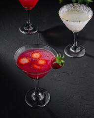 martini glasses of red and coconut alcohol drinks