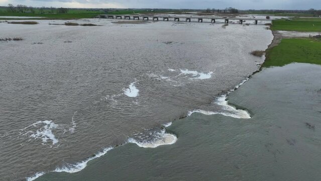 Water from the river Ijssel running into the Reevediep bypass for the first time aerial view near Kampen city during winter in Overijssel, Netherlands