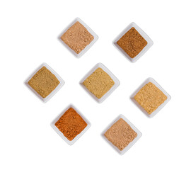 Various Indian Spices in Small White Bowls on white background