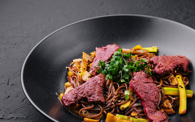 Chinese fried rice with beef on black plate