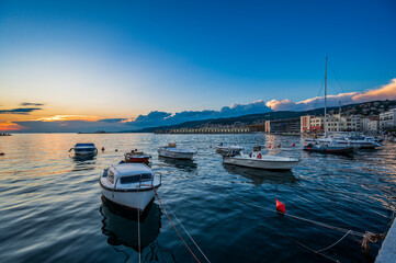 Dusk and night in Trieste. Between historic buildings and the sea. - 725478290