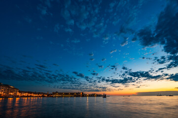 Dusk and night in Trieste. Between historic buildings and the sea. - obrazy, fototapety, plakaty