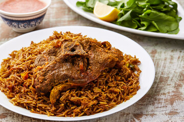 Meat Machboos or beef majboos rice with lemon slice served in dish isolated on table top view of...