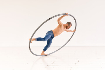 Male gymnast performing in Cyr wheel
