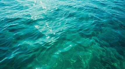 Fototapeta na wymiar Blue green surface of the ocean in Catalina Island California with gentle ripples on the surface and light refracting 