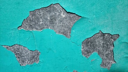 a piece of blue paint peeling off of a wall