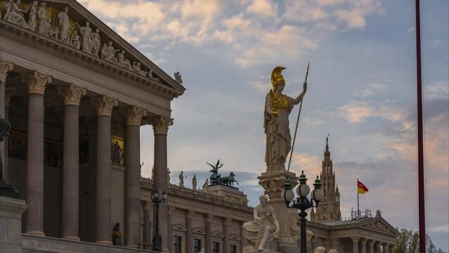 Sunset time-lapse of the statue of Athena at Vienna's Parliament building with Rathaus in the background