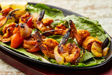 Grilled Shrimp served in dish isolated on table top view of arabic food