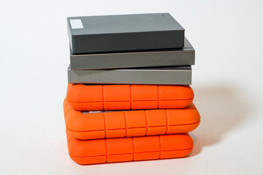 A stack of hard drives or hard disc drives on a white background. Data storage devices in a pile. Closer-up