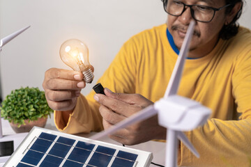 A man experimenting with using electricity generated from sunlight through solar panels to save energy