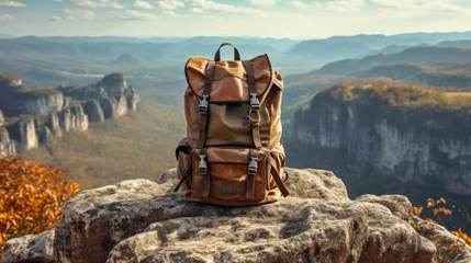 Deurstickers traveler's backpack standing on a rocky cliff, overlooking a breathtaking mountain vista, encapsulating the sense of achievement and serenity found in outdoor travel © Anastasia Shkut